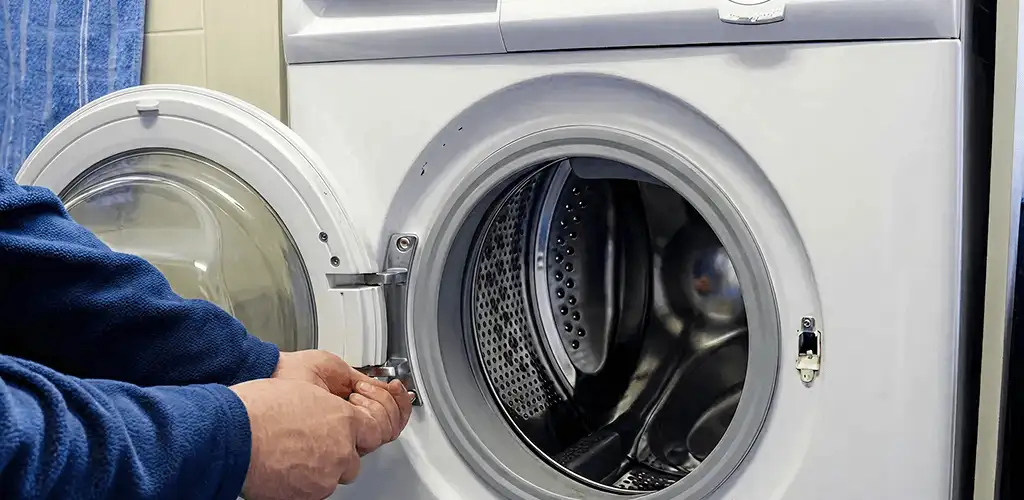 Washing machine repair handyman checking a front-load washer door and latch in Columbia, SC