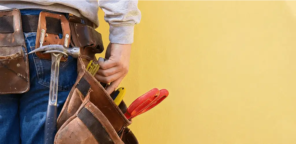 Handyman with tool belt ready for home repairs and maintenance in Columbia, SC