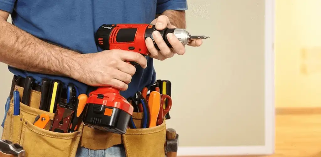 Handyman holding a power drill for home repairs and installations in Columbia, SC