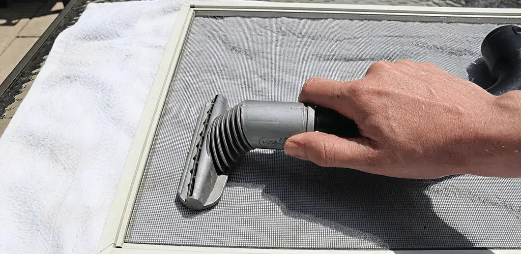 Window screen repair cleaning and fixing a damaged screen mesh in Columbia, SC